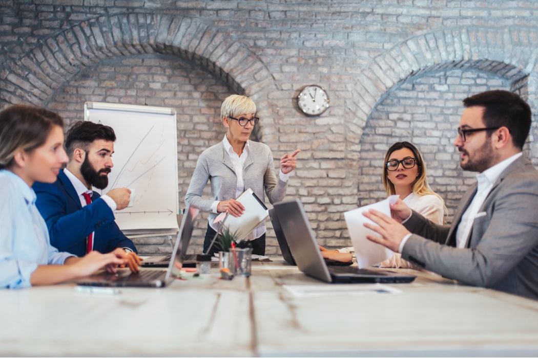 A group of colleagues sitting around a conference table.