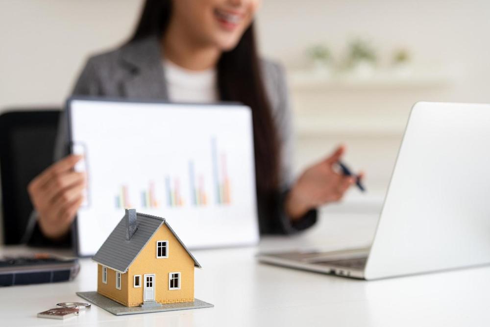 A mortgage adviser showing information to clients.