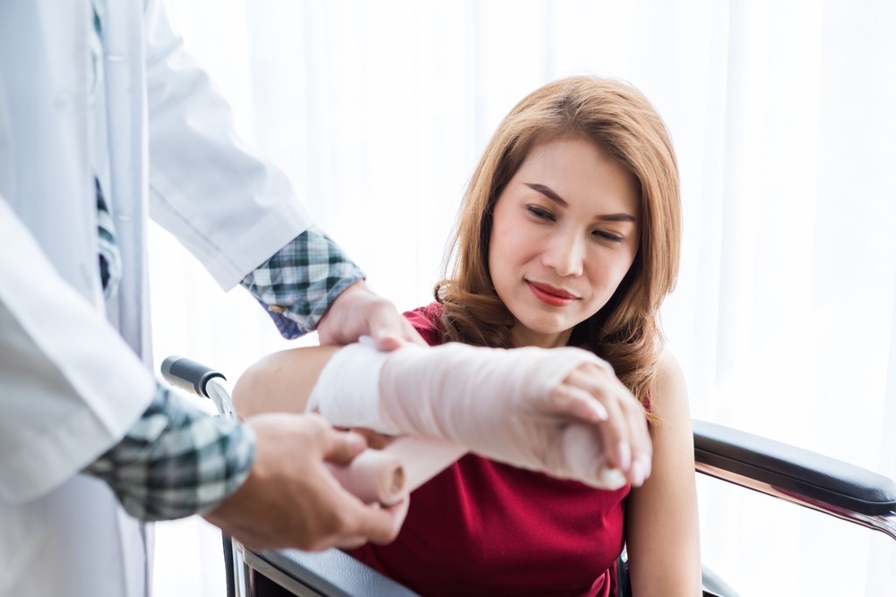 A woman having her arm placed in a cast